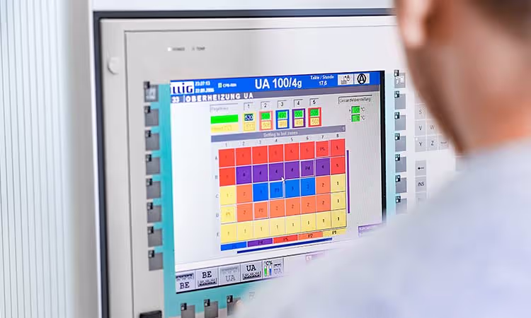 Güku Qualitätssicherung: man sieht einen Mitarbeiter am Bildschirm zur Steuerung der Produktion